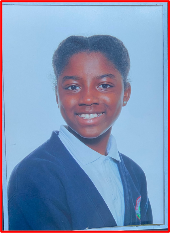 Orchid age 9. ‘Her posture has it one may say’ . Orchid, having her primary school picture taken which resembles a professional Law firm picture. The Bridge MAG. Image